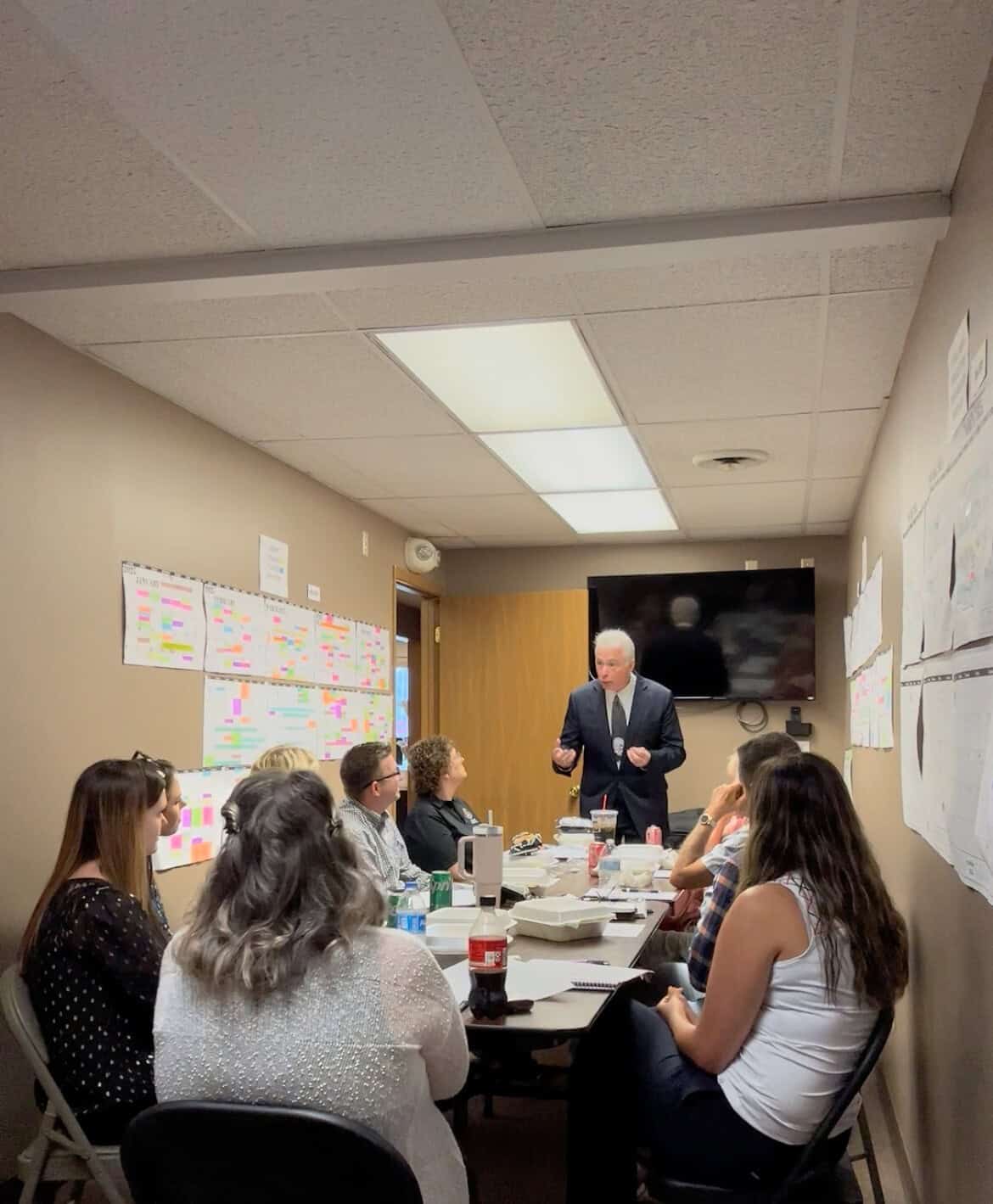 Business training session with a speaker and engaged participants in a conference room.
